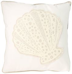 a white pillow with an embroidered scallop on it