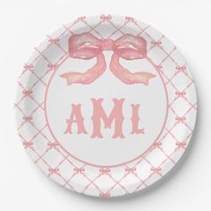 a plate with pink bows on it and the word aml written in large letters