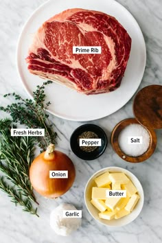 raw meat on a white plate with ingredients labeled