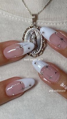 some nails with white and pink designs on them