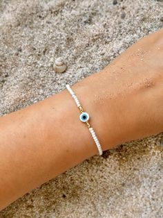 White Evil Eye Bracelet Dainty Evil Eye Bracelet Beaded Evil | Etsy Evil Eye Seed Bead Bracelet, White Friendship Bracelets With Evil Eye, White Evil Eye Friendship Bracelets, Spiritual Evil Eye Beaded Bracelets For Beach, Bohemian Evil Eye Bracelet With Tiny Beads For Beach, Bohemian Evil Eye Bracelet For Beach, White Evil Eye Bracelet With Tiny Round Beads, White Evil Eye Beaded Bracelets For Festivals, White Evil Eye Bracelets For Festival