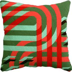 a green and red pillow with an abstract design on the front, sitting against a white background