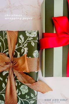 two presents wrapped in green and brown paper with red bows on them, sitting next to each other