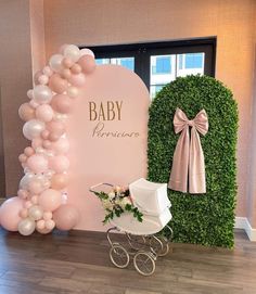 a baby shower is set up with balloons and a stroller for the baby to sit in