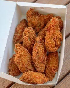 fried chicken in a box on a wooden table