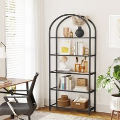 a room with a desk, chair and bookshelf in front of a window