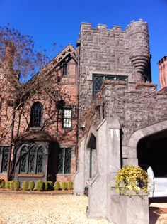 an old castle like building with lots of windows and stonework on the front entrance