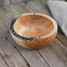 a wooden bowl sitting on top of a wooden table