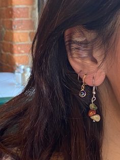 a close up of a person wearing some kind of earrings