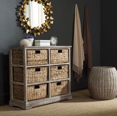 a dresser with wicker drawers and a mirror on the wall above it in a living room