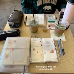 a person sitting at a table with a book and coffee in front of them on it