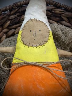 a stuffed animal sitting on top of a pumpkin in front of a wicker basket