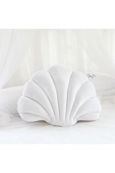 a large white pillow sitting on top of a bed