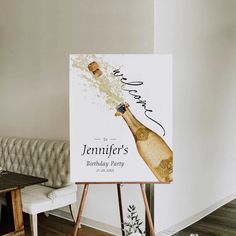 a birthday party sign with a champagne bottle on it