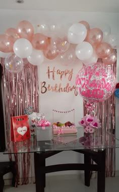 a birthday party with balloons, cake and decorations