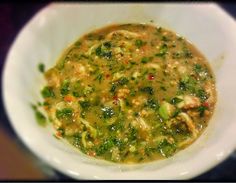 a white bowl filled with soup on top of a table