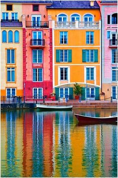 an apartment building is reflected in the water