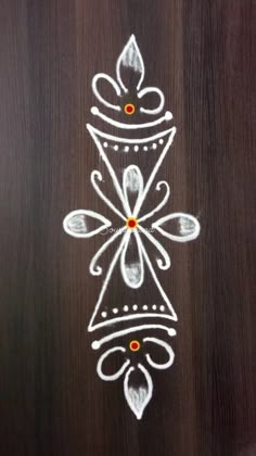 a wooden door decorated with white and orange designs