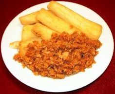 a white plate topped with fried food on top of a red table