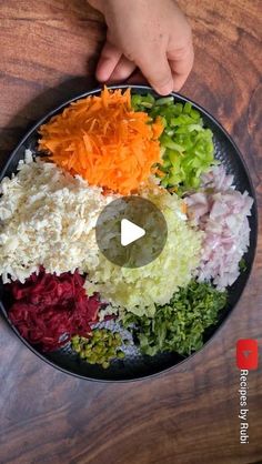 a person holding a plate full of chopped vegetables