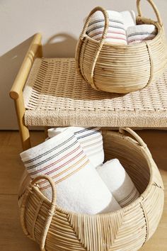 two wicker baskets with towels in them