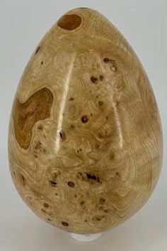 a wooden vase sitting on top of a white table