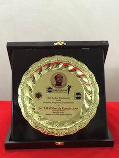 an award plaque is displayed on a red table