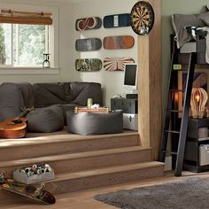 a living room filled with furniture and lots of decor on the wall next to a stair case