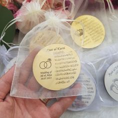 a person holding some wedding favors in their hand