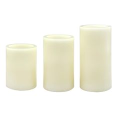 three white candles sitting next to each other