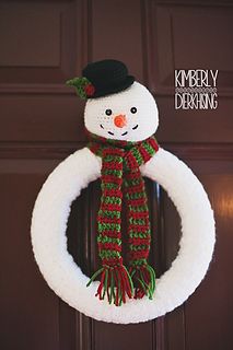 a snowman wreath hanging on the front door