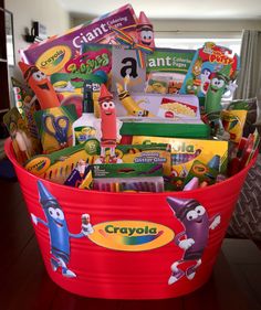 a red bucket filled with lots of toys