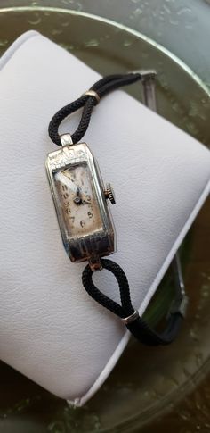 This 1935 ladies watch is really neat. It's art deco style can't be missed even though it is a dainty little watch. Wrist watches were just starting to catch on by then. This watch was made by Elgin and is 10kt white gold filled. It is in really good very vintage condition. It winds and the hands move but it is not currently running. If you plan to wear it to keep time it will need to be serviced.  IF this watch could talk, the stories it would tell... Art Deco White Gold Watches As Gift, Art Deco Watch Women, Art Deco White Gold Watches For Gift, Antique Adjustable Watches For Formal Occasions, Vintage Watches With Polished Finish For Evening, Art Deco Watches Ladies, Vintage Rectangular Adjustable Watch, Vintage Rectangular Adjustable Watches, Art Deco Watch