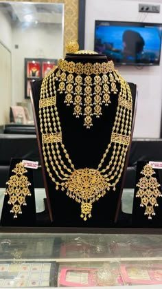 gold jewelry set on display at a store in the middle of an area with other items