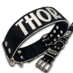 a black and white belt with the word thor printed on it's back side