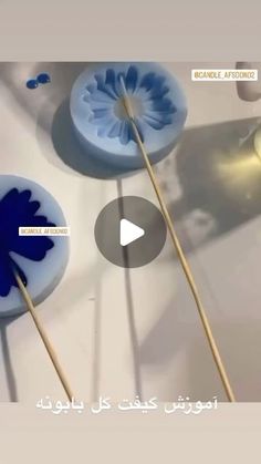 two blue and white lollipops sitting on top of each other