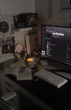 a desktop computer sitting on top of a desk next to a keyboard and monitor with headphones