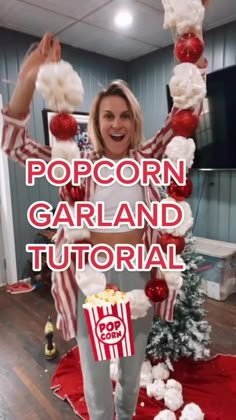 a woman is standing in front of a popcorn garland