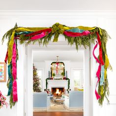 an open door with christmas decorations on the front and back doors, decorated in bright colors