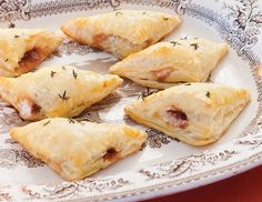 several pastries on a plate with herbs