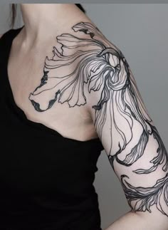 a woman with a tattoo on her arm