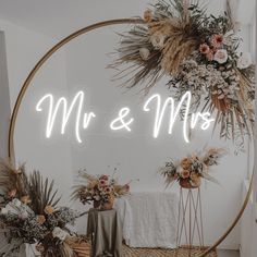 a round mirror with the words mr and mrs in front of it, surrounded by flowers