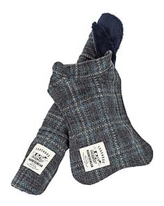 an oven mitt with a label on it and a blue plaid pattern in the middle