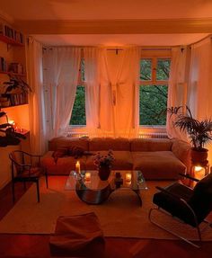 a living room filled with furniture and candles