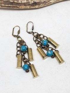 BEST SELLER! Turquoise is always a popular choice! Triple brass 22 caliber bullet casings and turquoise beadwork hung at graduated lengths from antique brass leverbacks. These are lightweight, stylish and little southwest in vibe. Length: Approx. 2 3/4" Would make an excellent December birthday gift! See our many selections utilizing turquoise. WANT THE MATCHING BRACELET? See our listing for our brass 9mm and 22 cal loaded charm bracelet using the same wonderful turquoise beadwork. They make a f 22 Caliber, Bullet Earrings, December Birthday Gifts, Bullet Casing, Bullet Jewelry, December Birthday, Leverback Earrings, Matching Bracelet, Matching Bracelets