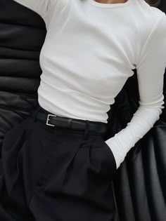 a woman in white shirt and black pants