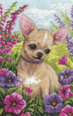 a small dog sitting in the grass with purple and pink flowers on it's side