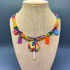 a necklace made with candy and lollipops on a mannequin neck