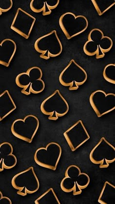 gold hearts and spades are arranged in the shape of rectangles on a black background