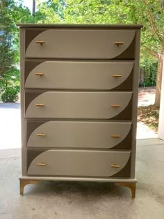 a chest of drawers sitting on top of a cement floor